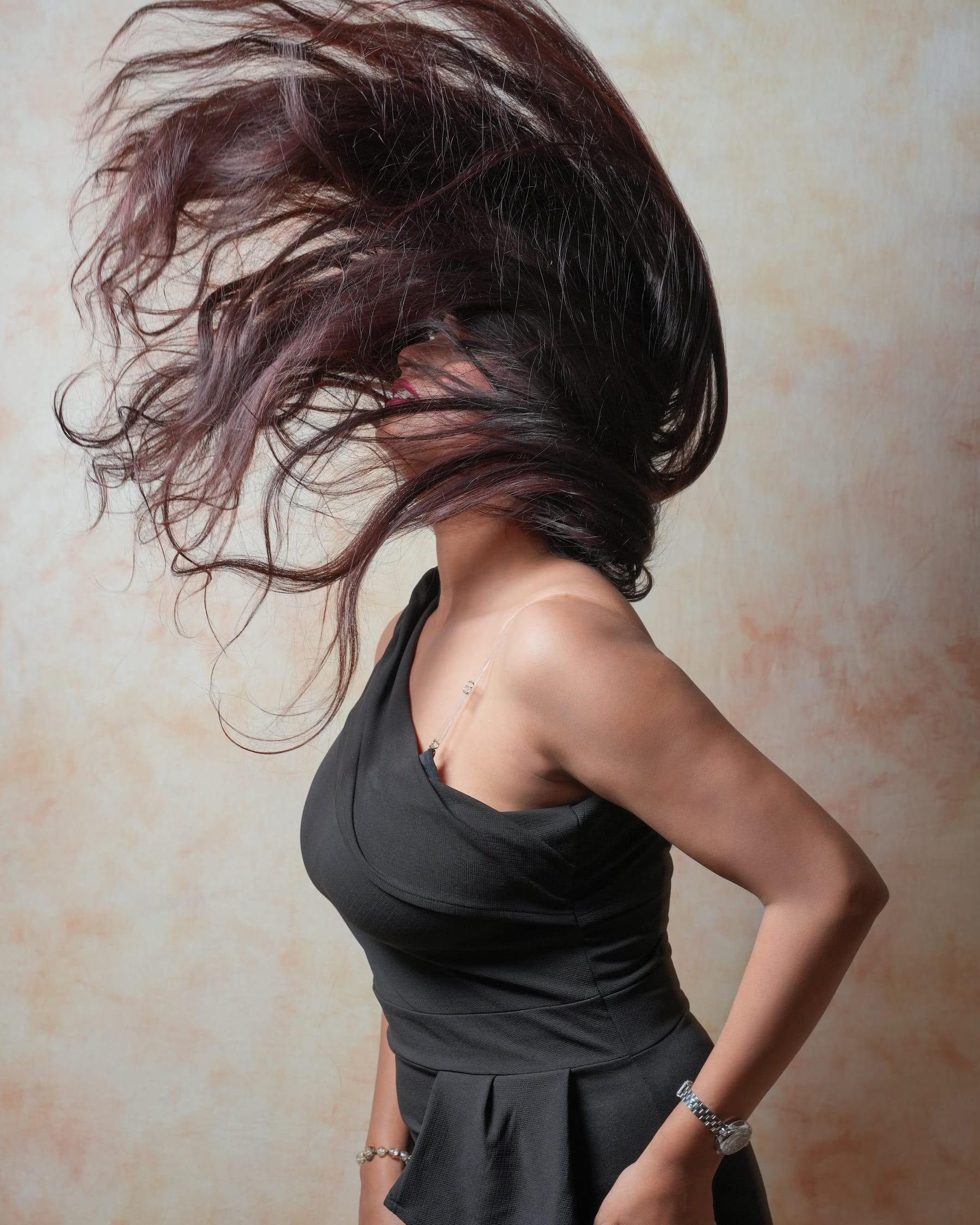 Close-up of caramel balayage waves falling over a shoulder
